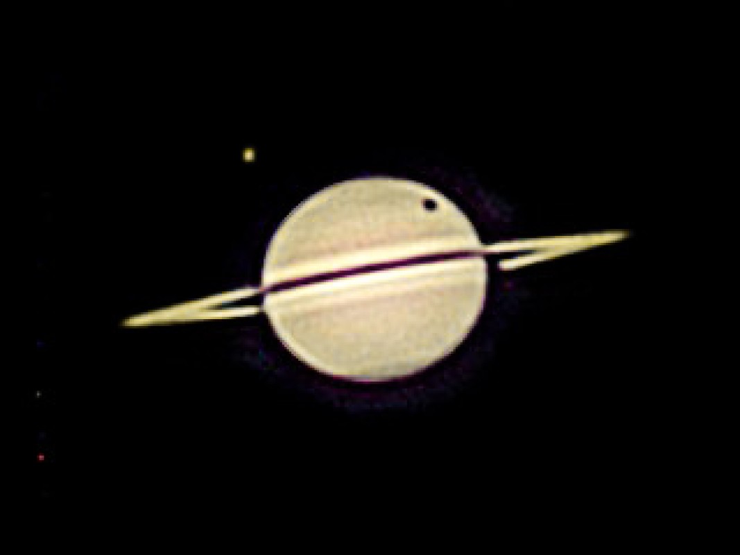 Titan's Shadow Over Saturn